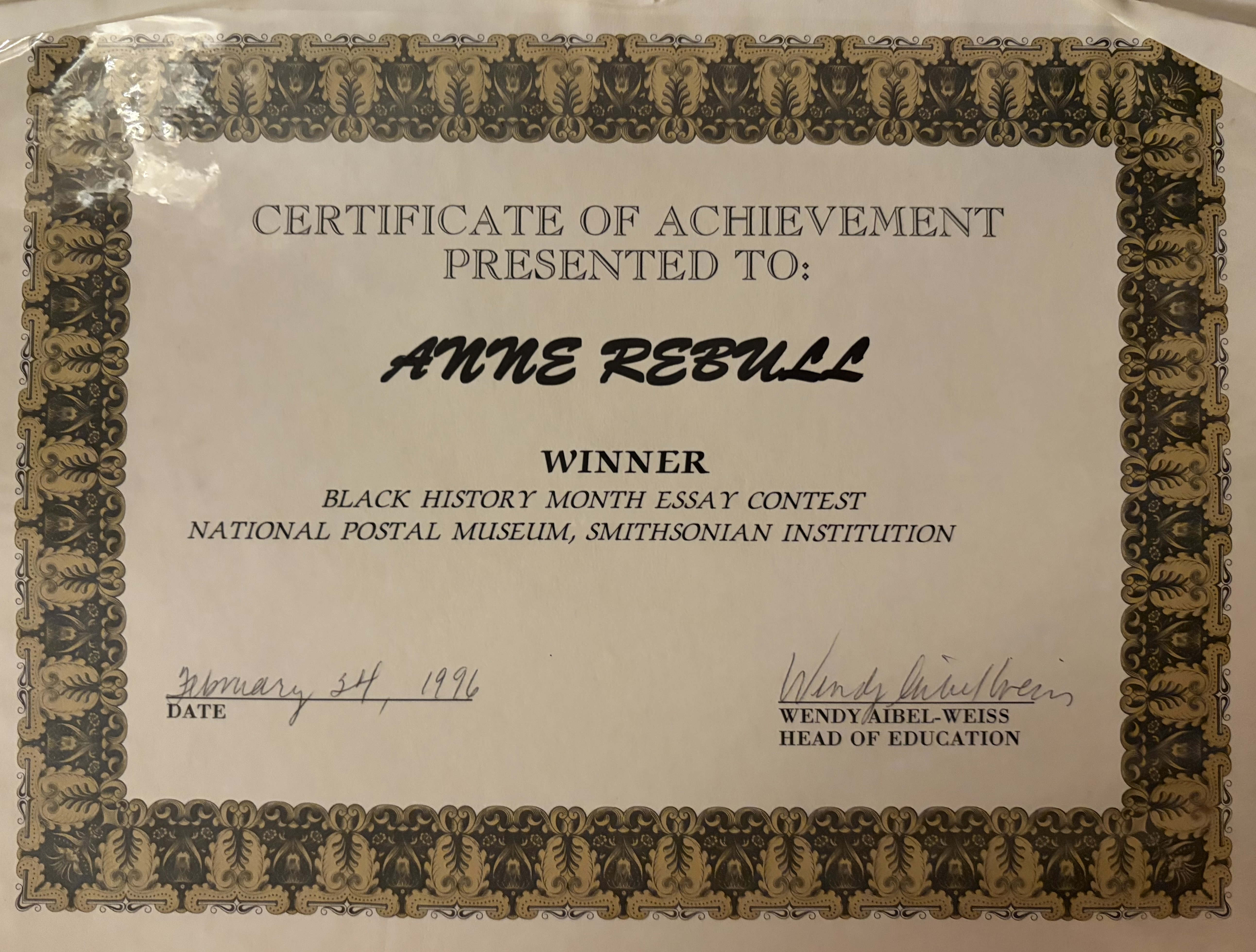 A certificate honoring a winning essay entry in a contest hosted by the National Postal Museum during Black History Month in 1996.
